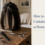 Curtain bangs parted at center with feathered sides framing the face